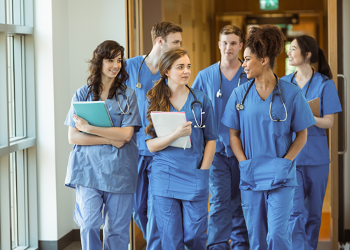 Group of healthcare staff walking together in a hallway
