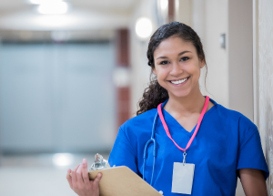 Healthcare professional holding a clipboard and smiling